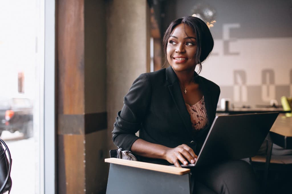 Black woman candidate working on a laptop in a modern workspace
