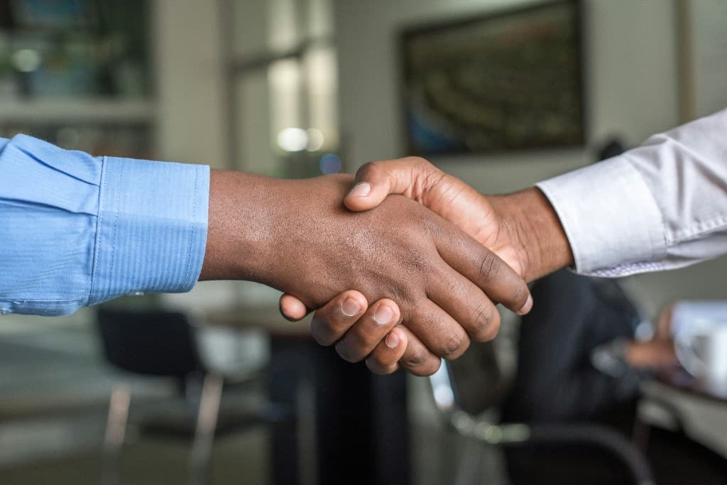 Two professionals shaking hands after a hiring agreement
